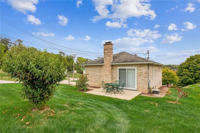 back of house featuring a yard, a patio, and central AC unit