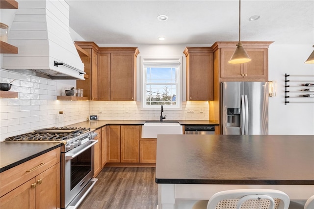 kitchen featuring pendant lighting, custom exhaust hood, sink, dark hardwood / wood-style flooring, and stainless steel appliances