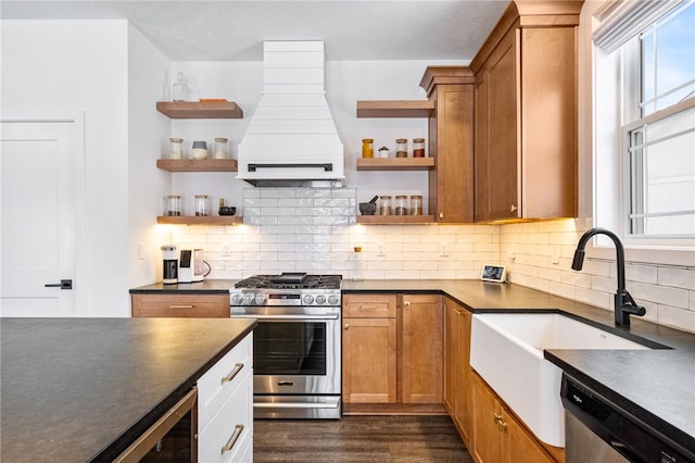 kitchen featuring stainless steel appliances, extractor fan, beverage cooler, dark wood-type flooring, and sink