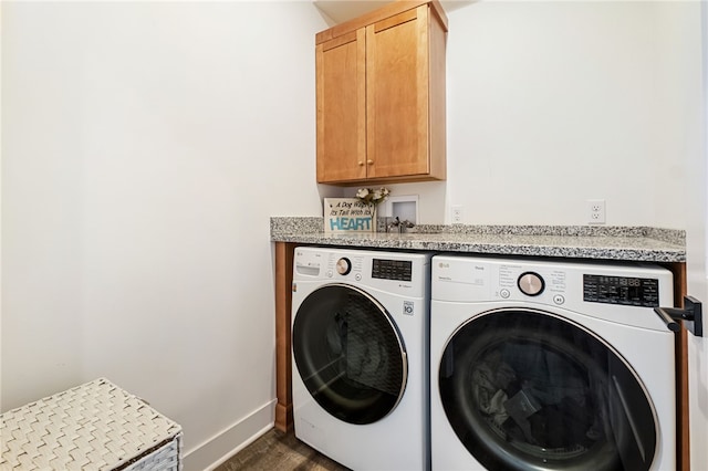 laundry area featuring cabinets and washing machine and clothes dryer