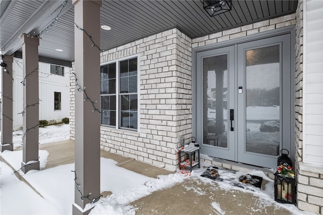 view of snow covered property entrance