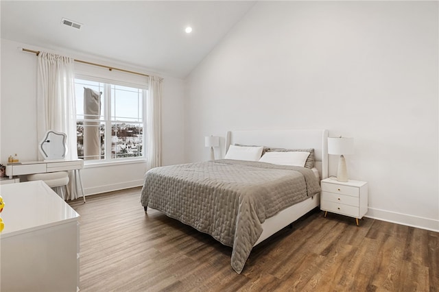 bedroom featuring dark hardwood / wood-style floors and vaulted ceiling