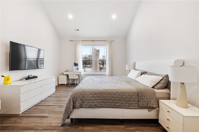 bedroom featuring dark hardwood / wood-style flooring and vaulted ceiling