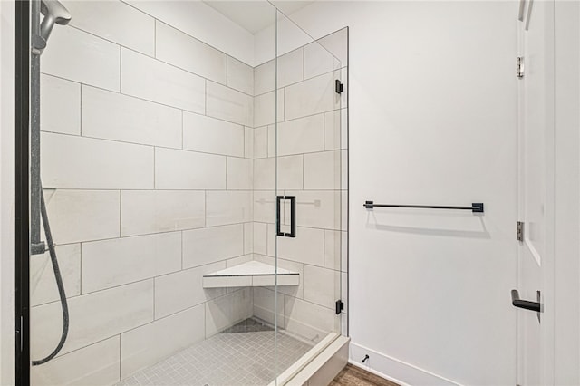 bathroom featuring a shower with shower door