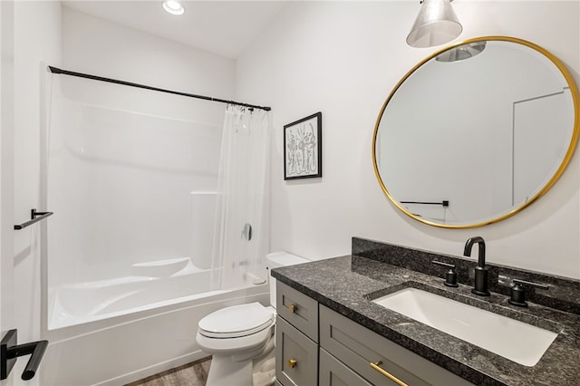 full bathroom with shower / bath combo with shower curtain, vanity, wood-type flooring, and toilet