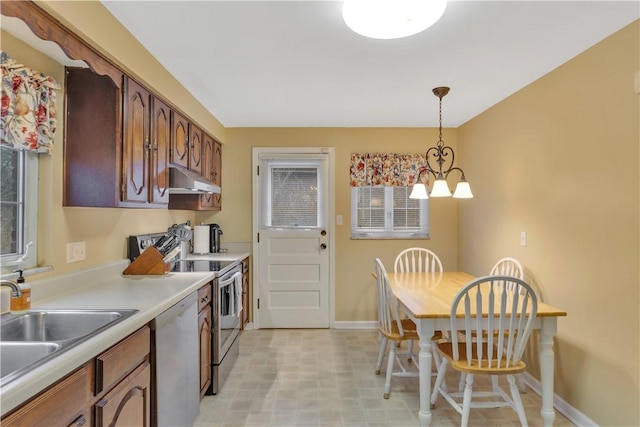 kitchen featuring stainless steel range with electric cooktop, an inviting chandelier, white dishwasher, sink, and decorative light fixtures