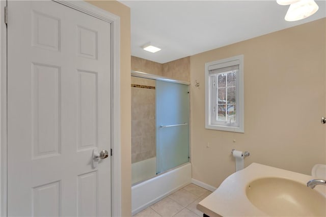 bathroom with sink, bath / shower combo with glass door, and tile patterned flooring