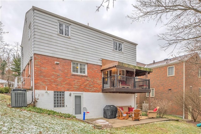 back of house with a balcony, a patio, and central AC