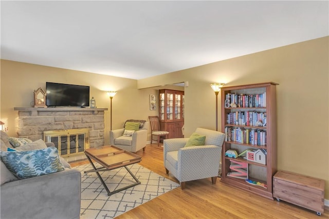 living room with light hardwood / wood-style floors and a fireplace