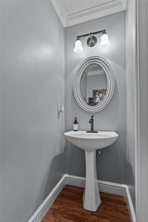 bathroom with wood-type flooring and ornamental molding