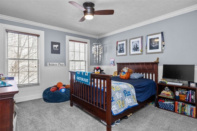 carpeted bedroom featuring a textured ceiling, ceiling fan, and crown molding