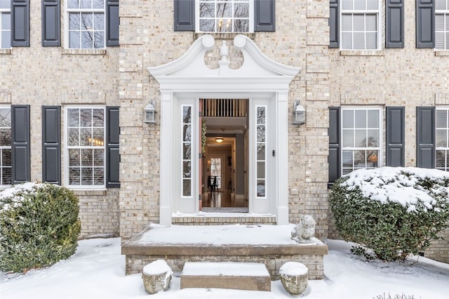 view of snow covered property entrance