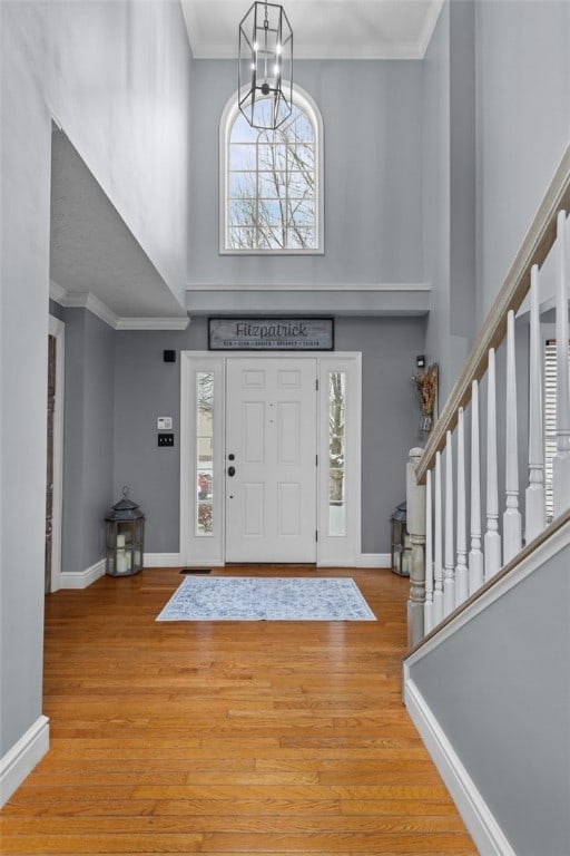 foyer featuring crown molding and light hardwood / wood-style flooring