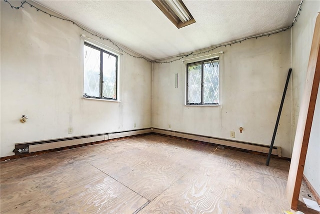 spare room with a textured ceiling and plenty of natural light