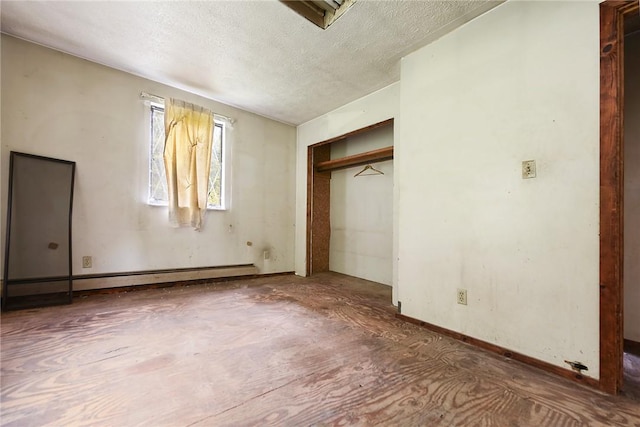 unfurnished bedroom with a baseboard radiator and a textured ceiling