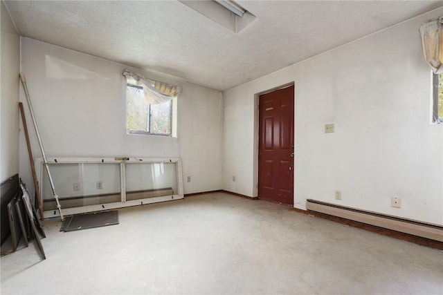 spare room with a baseboard radiator and a textured ceiling