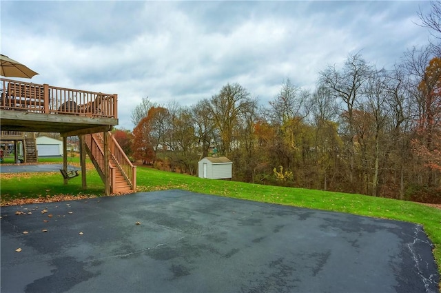 view of patio with a storage unit and a wooden deck