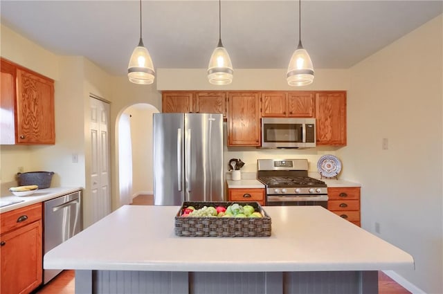 kitchen featuring a kitchen island, pendant lighting, and appliances with stainless steel finishes