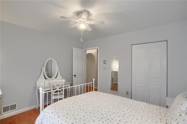 bedroom with ceiling fan, a closet, and hardwood / wood-style floors