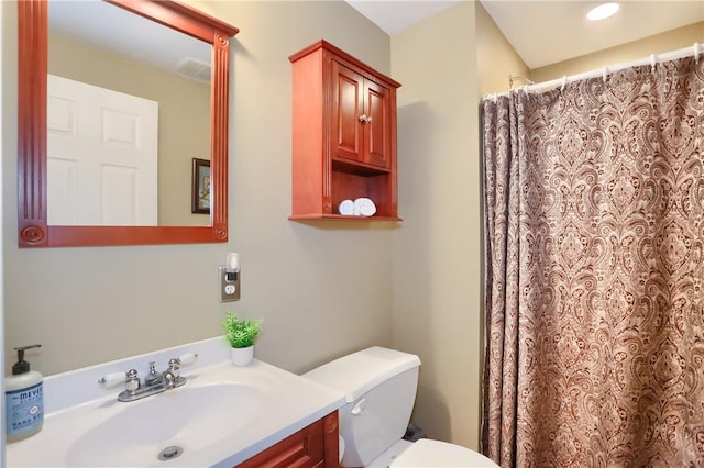 bathroom featuring vanity, curtained shower, and toilet