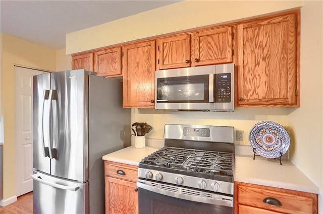 kitchen with stainless steel appliances and light wood-type flooring