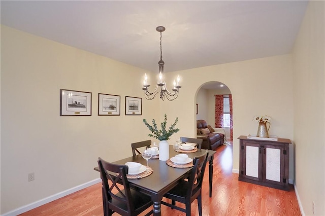 dining room with a chandelier and light hardwood / wood-style floors