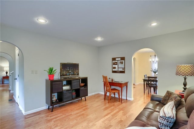 living room featuring light hardwood / wood-style floors and a chandelier