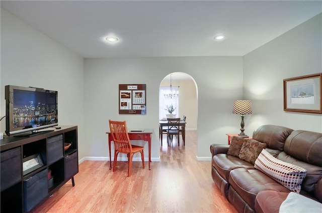 living room featuring light hardwood / wood-style flooring and a chandelier