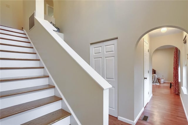 staircase with hardwood / wood-style floors