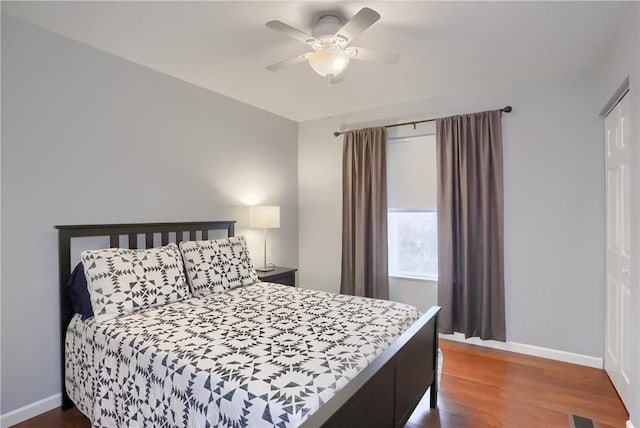 bedroom with dark hardwood / wood-style floors and ceiling fan