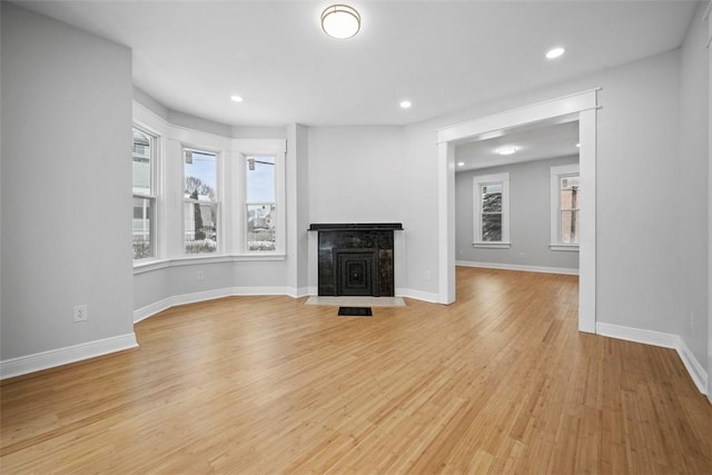 unfurnished living room with light hardwood / wood-style flooring