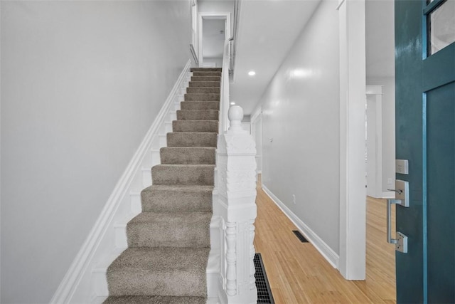 stairs featuring wood-type flooring