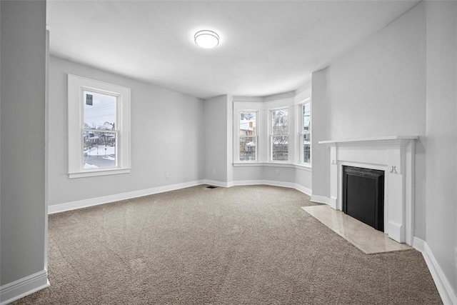 unfurnished living room featuring carpet flooring