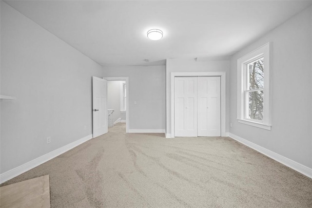 unfurnished bedroom featuring a closet and carpet