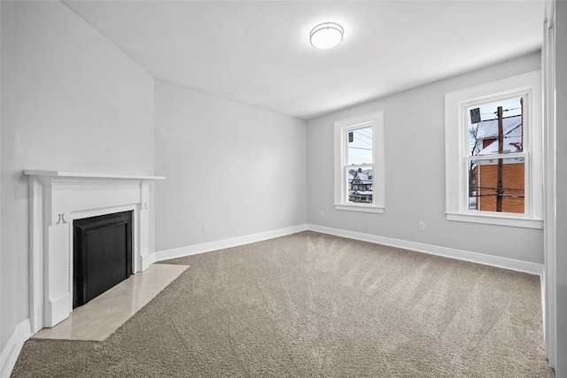 unfurnished living room featuring light colored carpet