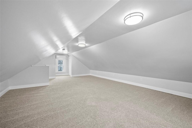 bonus room with lofted ceiling and carpet floors