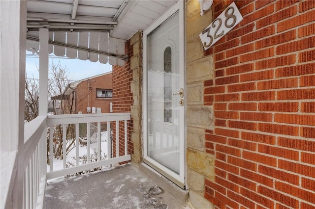 view of snow covered property entrance