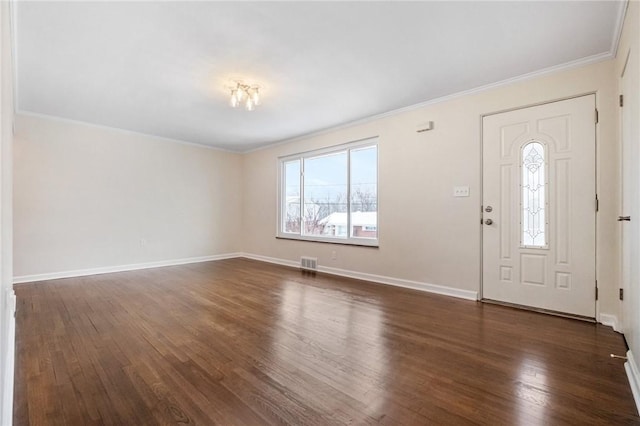 foyer entrance featuring crown molding and dark wood-type flooring