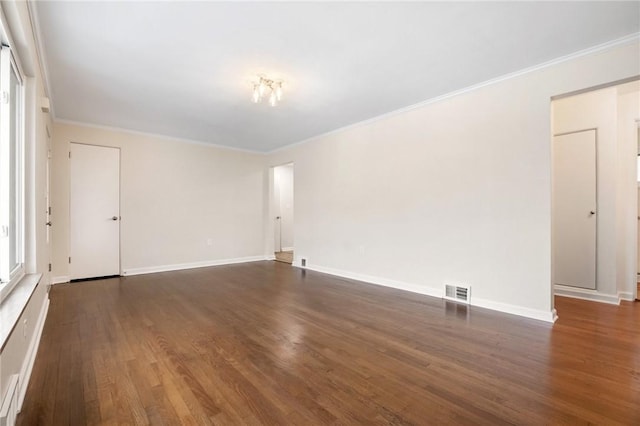 spare room with dark hardwood / wood-style flooring and ornamental molding