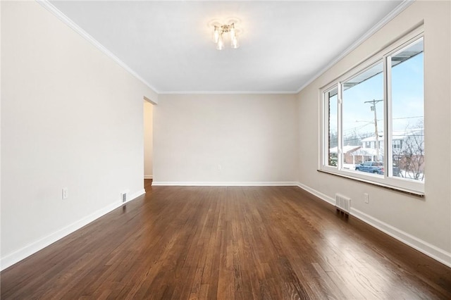 unfurnished room with ornamental molding and dark wood-type flooring