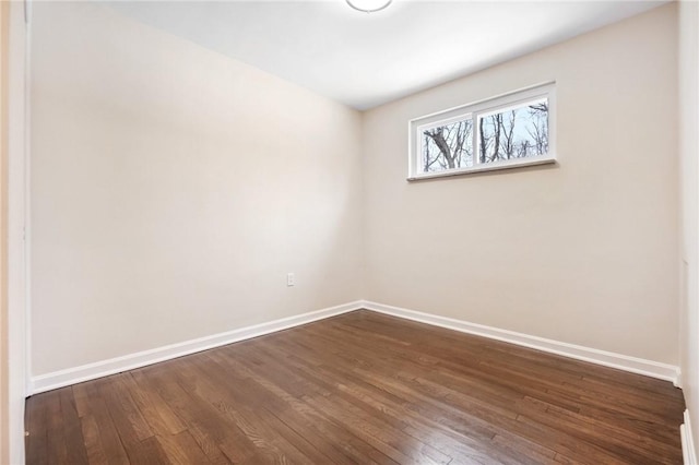 spare room with dark hardwood / wood-style floors