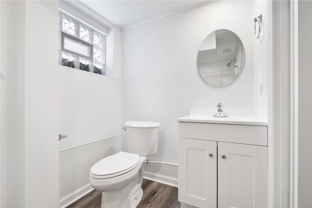 bathroom with vanity, wood-type flooring, and toilet