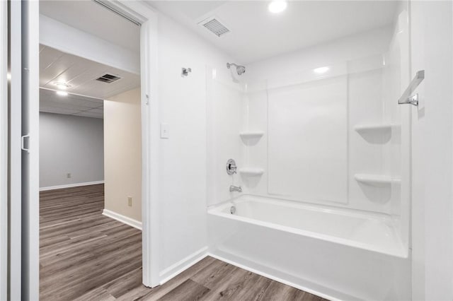 bathroom featuring shower / tub combination and hardwood / wood-style floors