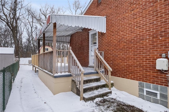 view of snow covered property entrance