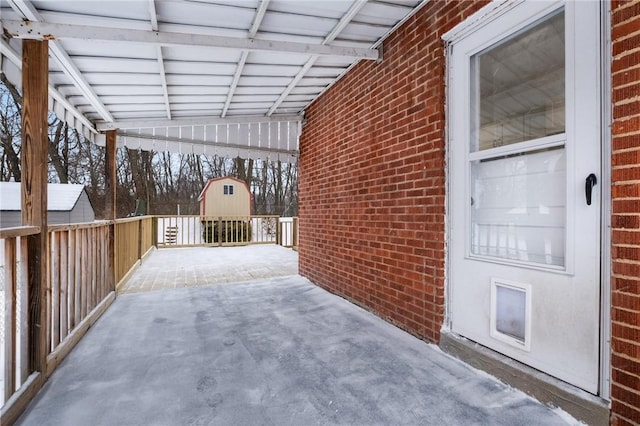 view of patio / terrace featuring a storage shed