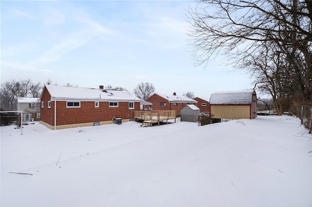 exterior space with a deck and a storage shed