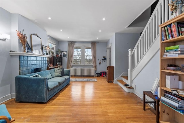 living room featuring radiator heating unit and light hardwood / wood-style flooring