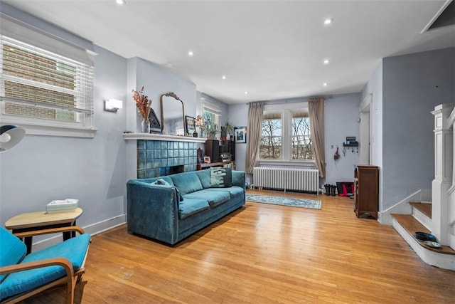 living room featuring light wood-type flooring and radiator heating unit