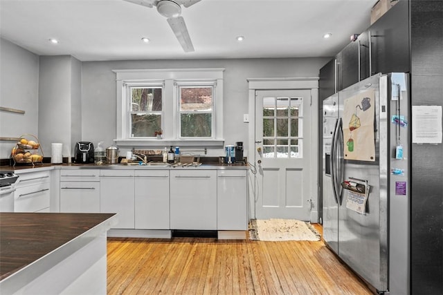 kitchen with white cabinetry, stainless steel fridge, plenty of natural light, and ceiling fan