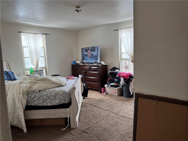 carpeted bedroom featuring cooling unit and multiple windows